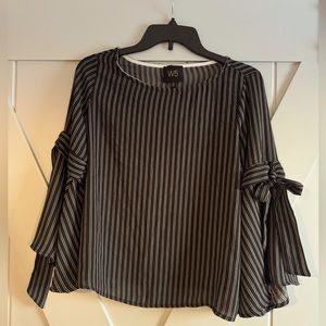 Women’s size small black and ivory blouse. Super cute bow details on arms.